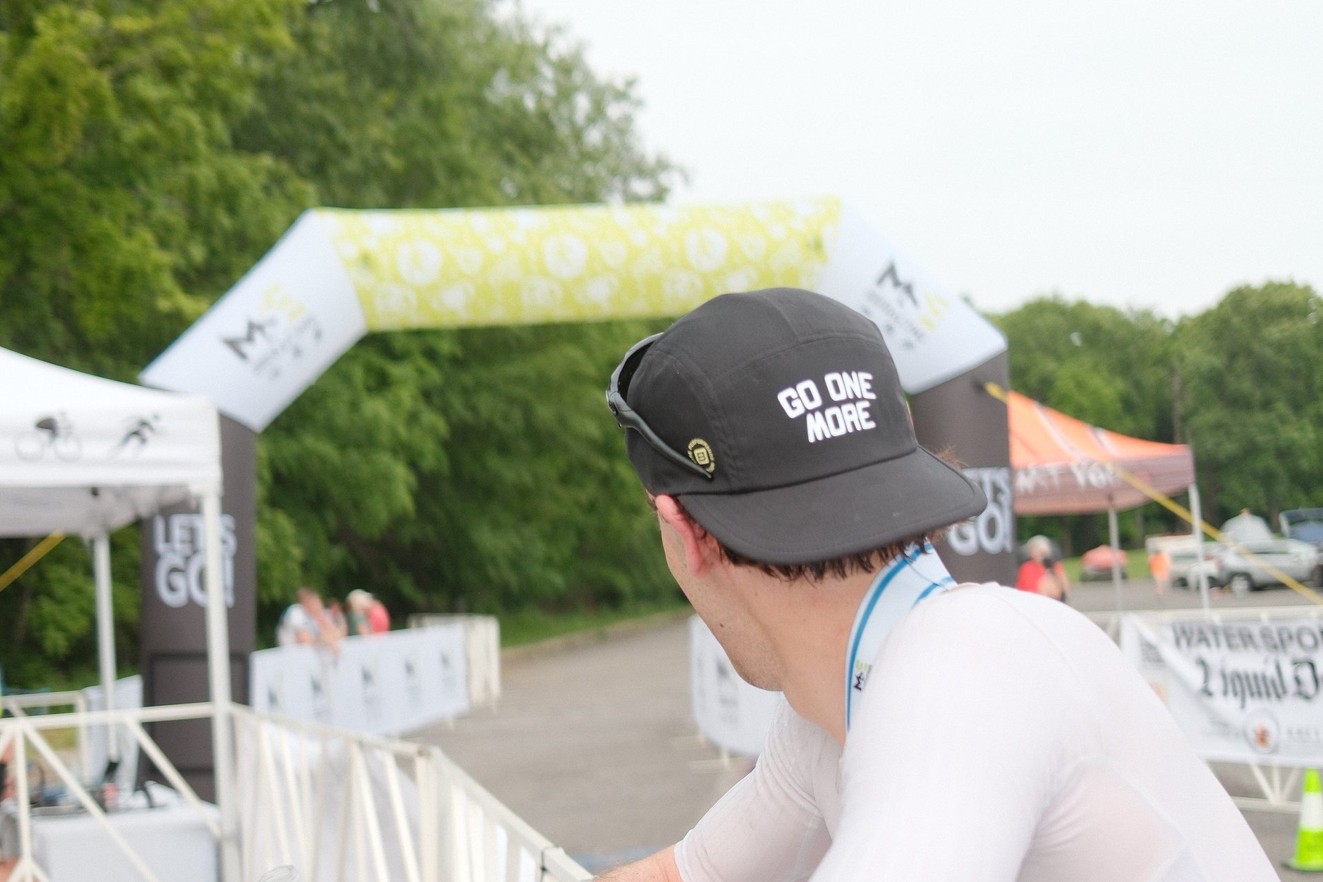 Athlete looking toward a race-day finish arch