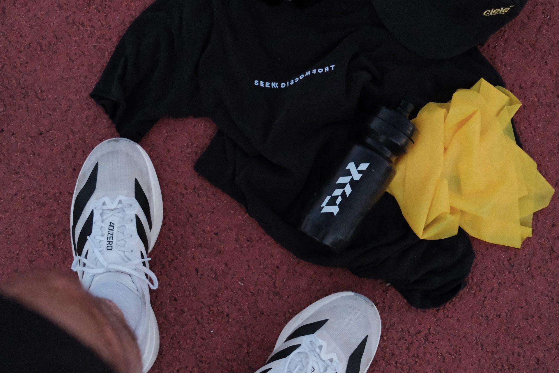 Running shoes and training gear laid out on a track